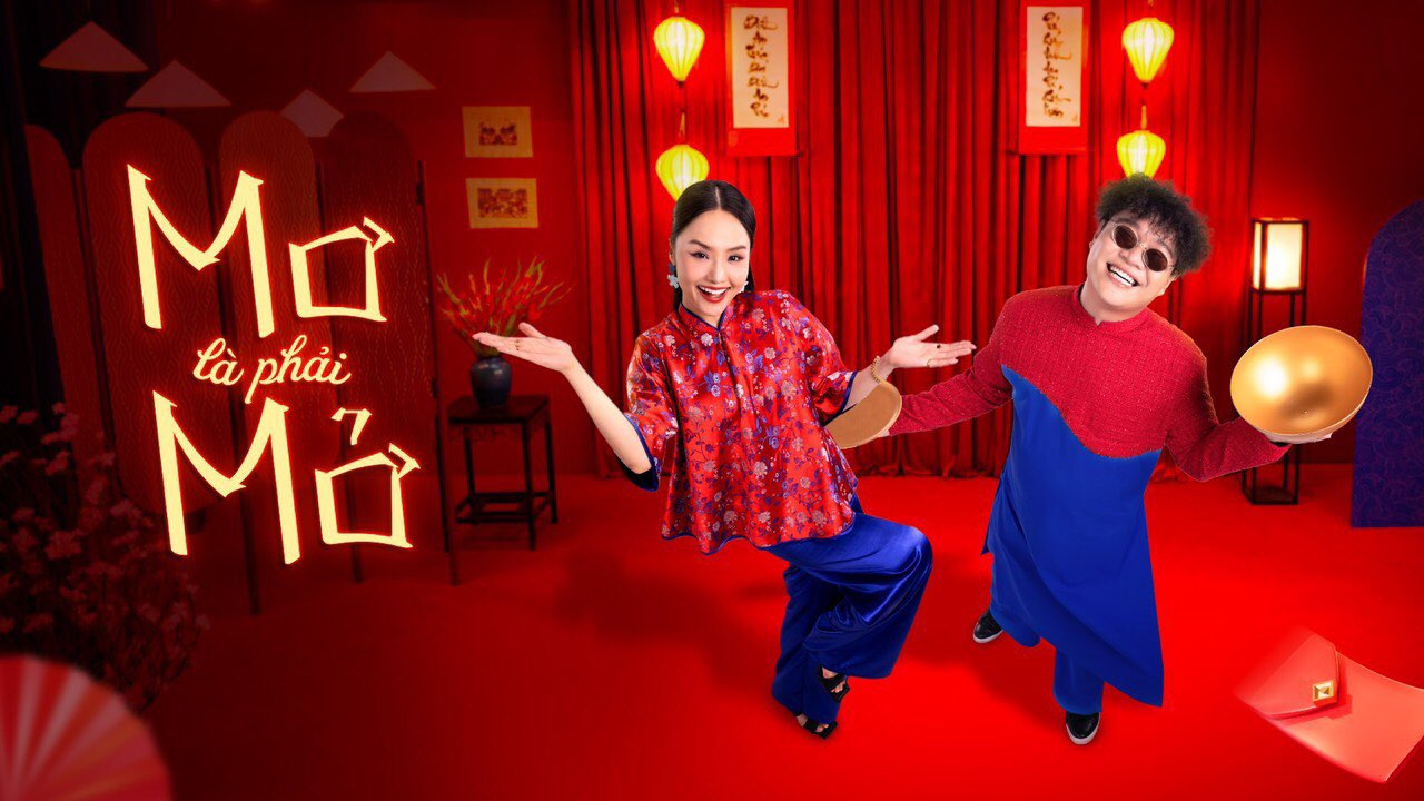 Description: A person and person dancing in front of a red curtainDescription automatically generated