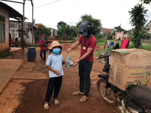 Tổ Covid-19 cộng đồng bon Bu N’Doh, xã Đắk Wer chuyển các phần quà đến tận tay các em nhỏ trong bon.